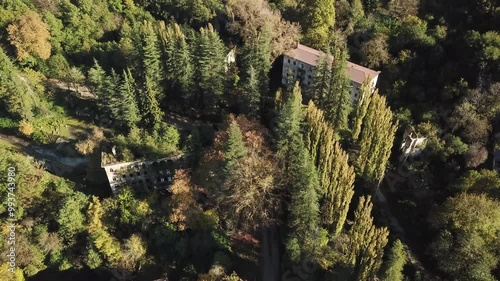 Aerial video. A shot above an abandoned house in the mountains of Abkhazia in Akarmara. Stone walls and windows without glass, the wall is destroyed photo