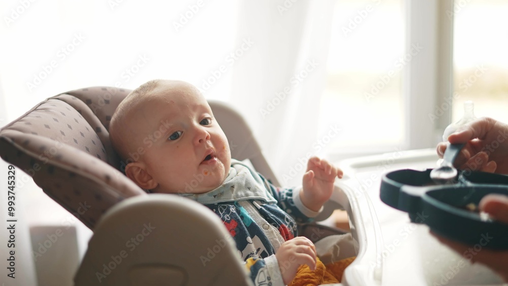 Healthy food. Cute baby boy face. beautiful a baby eats dirty. Healthy food family concept. mother feeds her daughter baby with a spoon, the child fun is dirty. newborn baby breakfast Healthy food. Cute baby boy face. beautiful a baby eats dirty. Healthy food family concept. mother feeds her daughter baby with a spoon, the child fun is dirty. newborn baby breakfast
