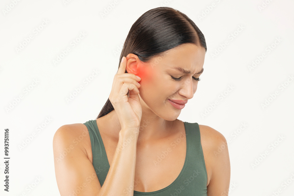 Lady touching sore ear, suffering from otitis with red accent, frowning young woman from strong ear pain feeling painful discomfort, white studio background Lady touching sore ear, suffering from otitis with red accent, frowning young woman from strong ear pain feeling painful discomfort, white studio background