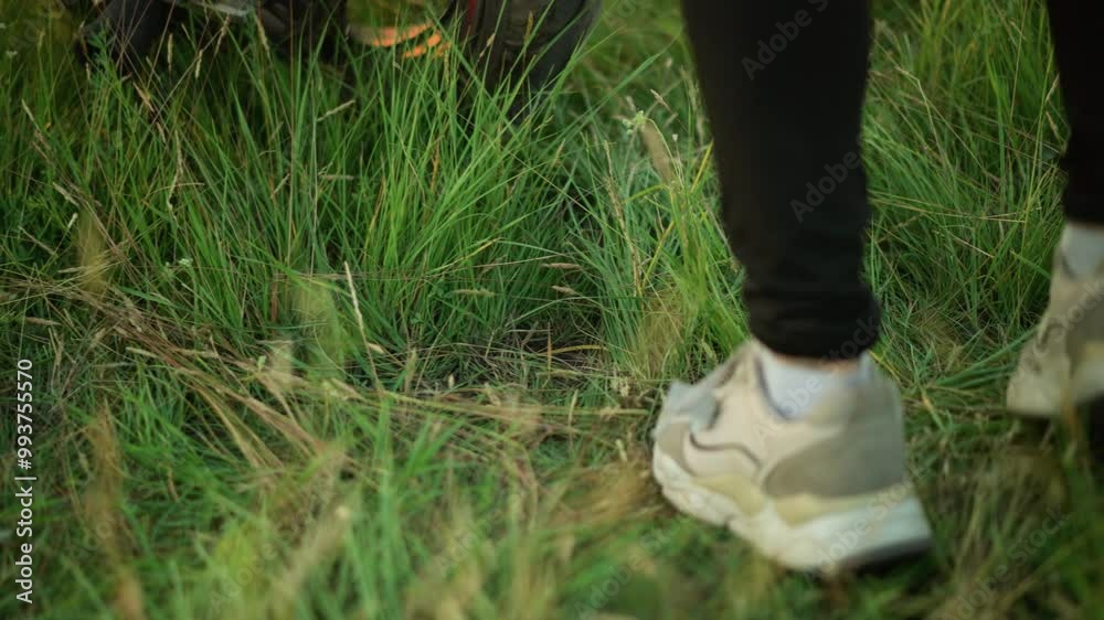 Close-up of a person wearing sneakers jumping on a grassy field near a bike Close-up of a person wearing sneakers jumping on a grassy field near a bike