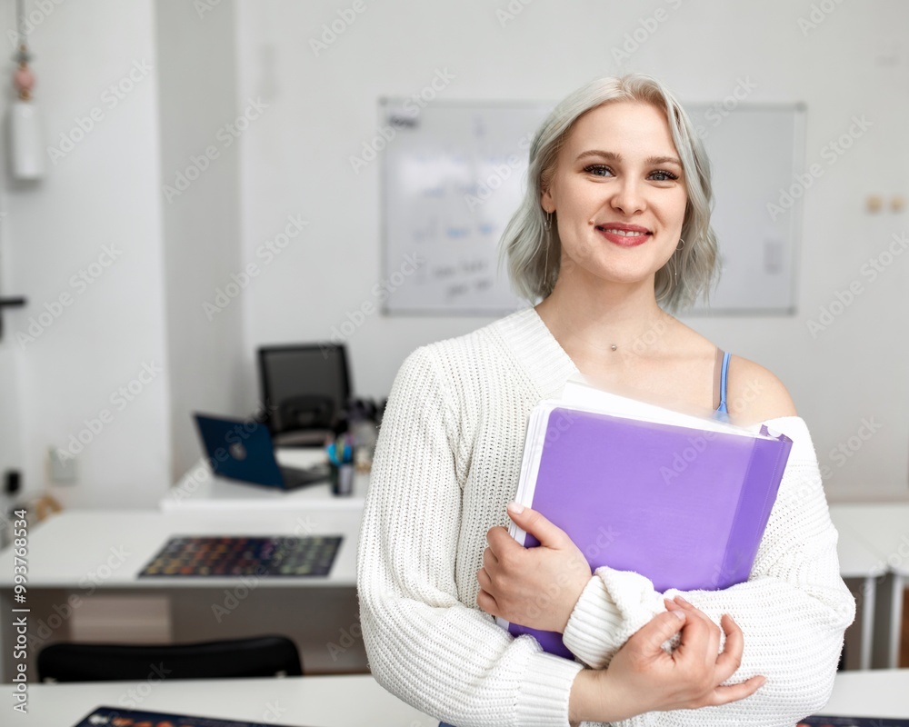 Photo of a pretty young woman working at a school. Online foreign language teacher Photo of a pretty young woman working at a school. Online foreign language teacher
