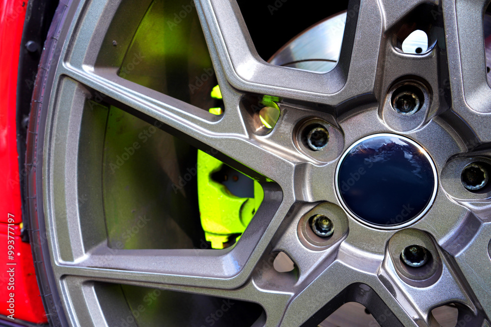 Alloy wheel with calipers and racing brakes of the sport car. Racing brake disc and low profile tyres. Race car test driving. Lower-profile tires of drag and drift cars. High-performance sports cars. Alloy wheel with calipers and racing brakes of the sport car. Racing brake disc and low profile tyres. Race car test driving. Lower-profile tires of drag and drift cars. High-performance sports cars.