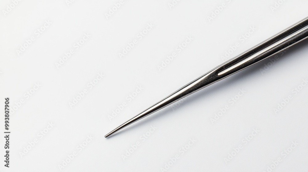 A pair of tweezers is shown against a plain white backdrop. A pair of tweezers is shown against a plain white backdrop.