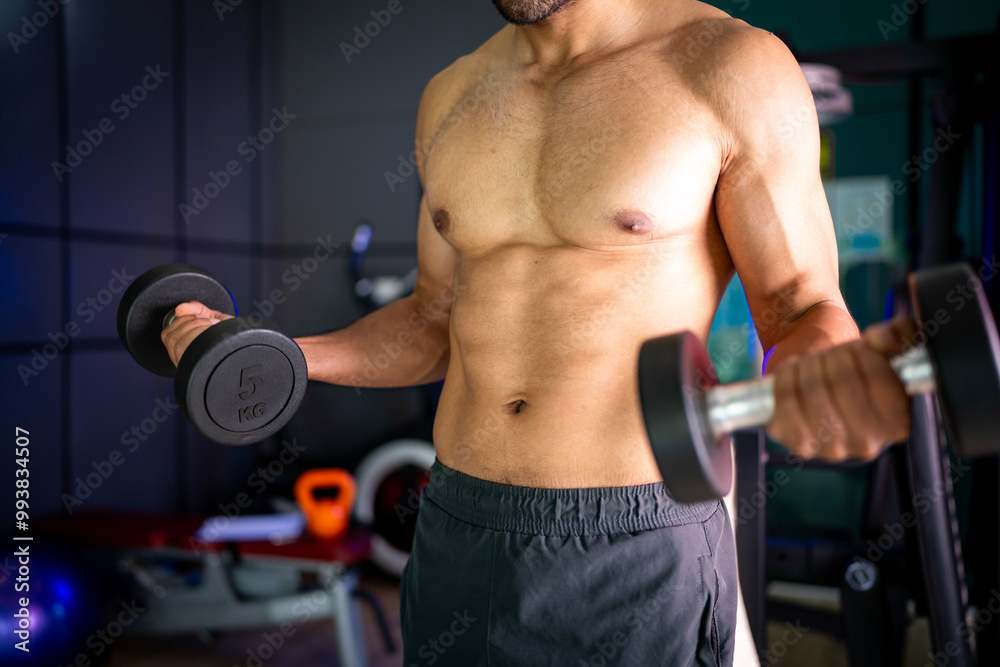 A strong Asian man is exercising to build muscle.. A strong Asian man is exercising to build muscle..