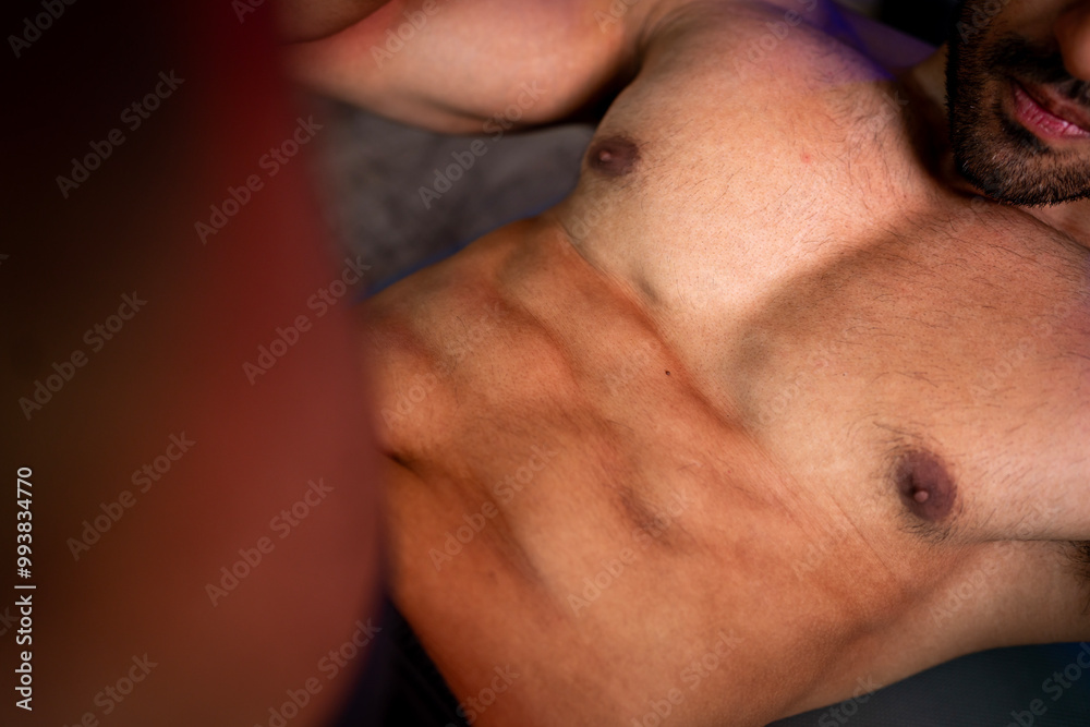 Naklejka premium A strong Asian man is exercising to build muscle..
