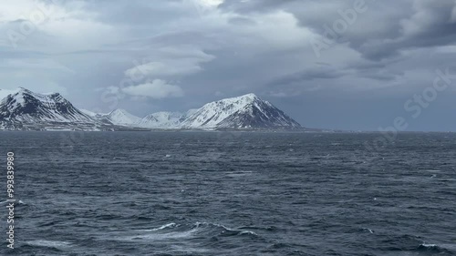 Isfjord, Svalbard, Spitzbergen, Norway - arriving by cruise ship from Iceland entering fjord on overcast day with snow covered archipelago photo