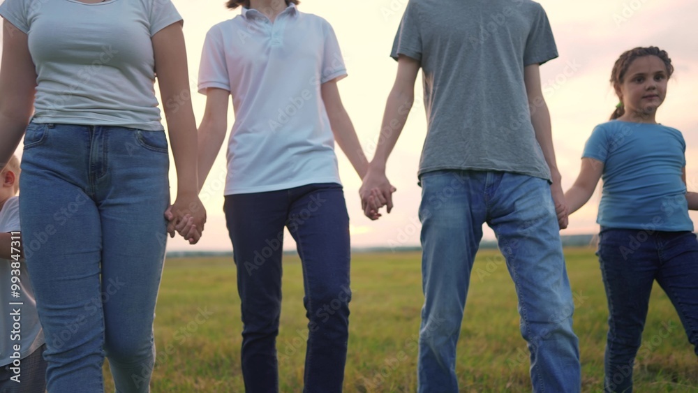 large family walks in the park. friendly group of people holding hands walk in nature in the park support each other. happy family kid dream concept. big family lifestyle concept large family walks in the park. friendly group of people holding hands walk in nature in the park support each other. happy family kid dream concept. big family lifestyle concept