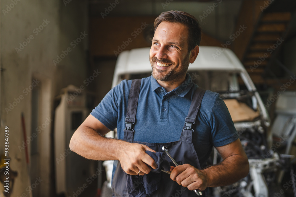 car mechanic holding cloth clean tools with open engine in background car mechanic holding cloth clean tools with open engine in background