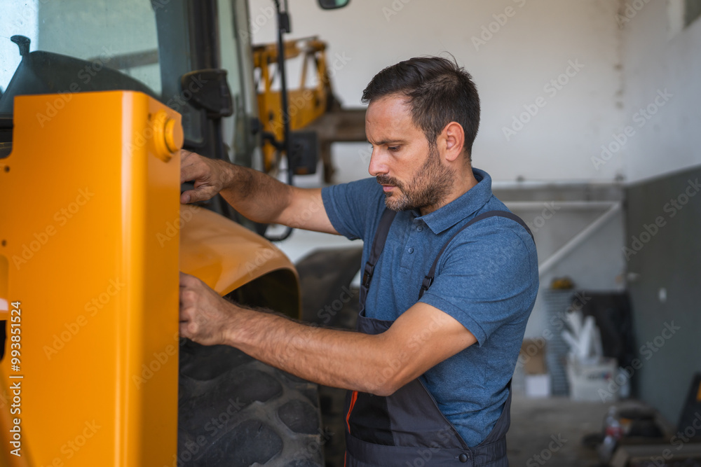 Car mechanic inspect heavy machinery in workshop setting indoors Car mechanic inspect heavy machinery in workshop setting indoors