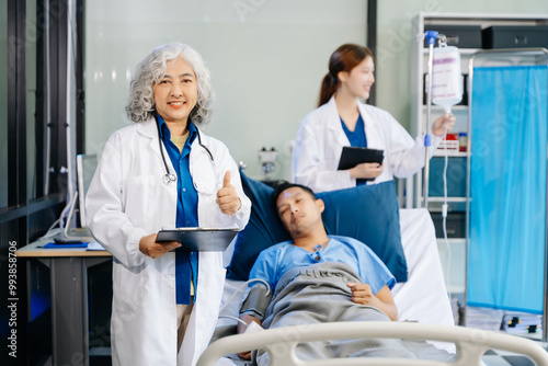 Hospital Ward Male and Male Professional Asian Doctors Talk with a Patient, Give Health Care Advice,