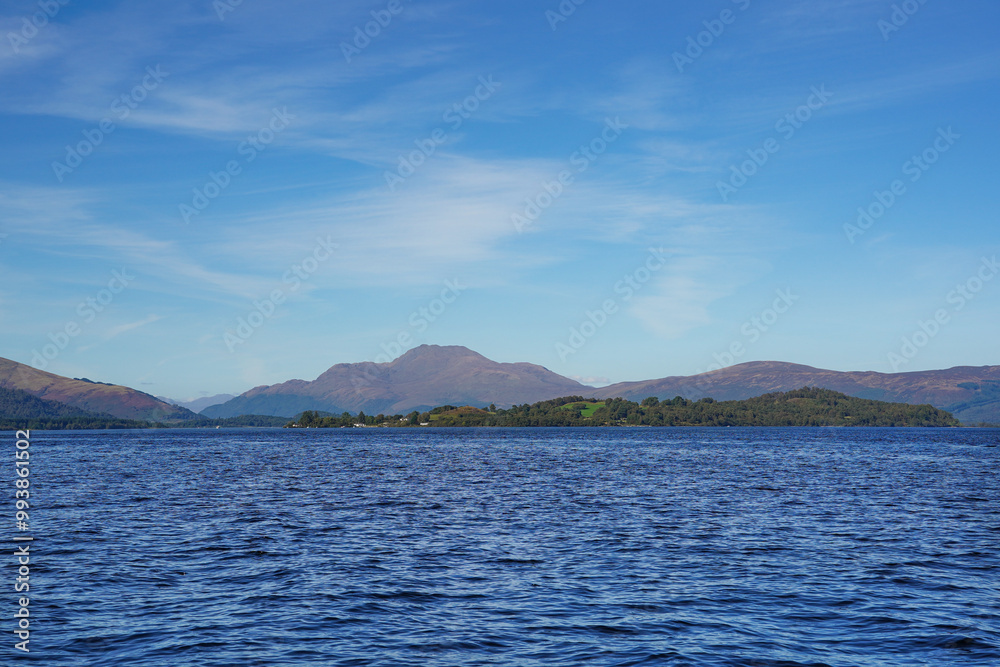 Inchmurrin island in Loch Lomond with Ben Lomond in the background. Inchmurrin is a freshwater island.. It is part of the Loch Lomond and The Trossachs National Park Inchmurrin island in Loch Lomond with Ben Lomond in the background. Inchmurrin is a freshwater island.. It is part of the Loch Lomond and The Trossachs National Park
