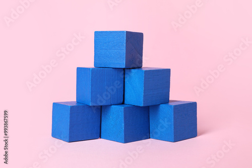 Many blank blue cubes on pink background