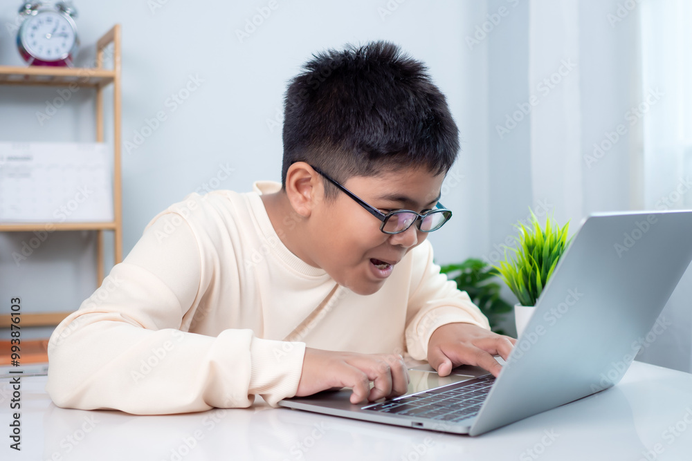 Asian boy student using computer laptop learning. Educational of tech concept, Staying at home, Presenting a modern educational way of life. Virtual internet online class from school teacher. Asian boy student using computer laptop learning. Educational of tech concept, Staying at home, Presenting a modern educational way of life. Virtual internet online class from school teacher.