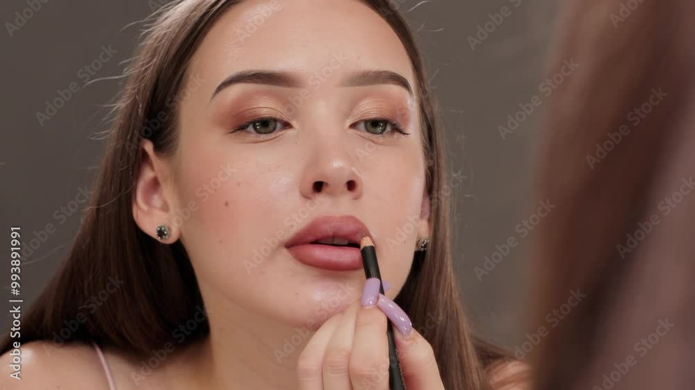 Beautiful girl does lips make-up. Professional makeup and cosmetology skin care. Beautiful girl does lips make-up. Professional makeup and cosmetology skin care.