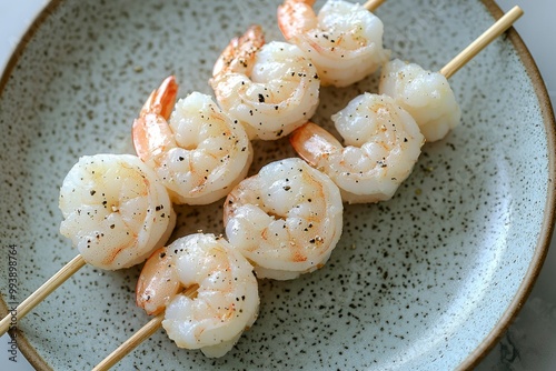 Grilled Shrimp Skewers with Black Pepper on a White Plate photo