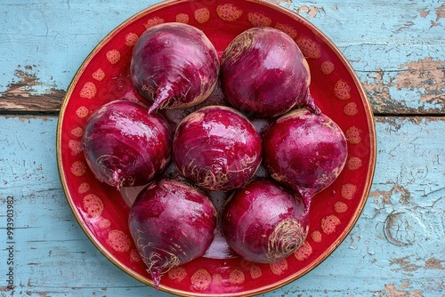 A Group of Beets on a Red and Gold Decorative Plate photo