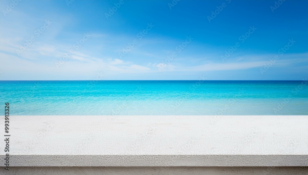 Fototapeta premium Concrete table top against the background of the sea on the beach. Empty white countertop for product presentation with blue water and sky. Outdoor mockup