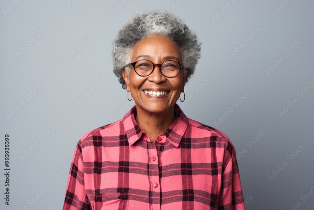 Portrait of a satisfied afro-american elderly woman in her 90s wearing a comfy flannel shirt over minimalist or empty room background Portrait of a satisfied afro-american elderly woman in her 90s wearing a comfy flannel shirt over minimalist or empty room background