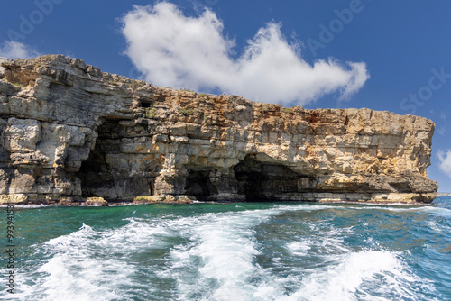 Obraz na płótnie View from the water of picturesque coastline with cliffs and caves by Adriatic Sea, Polignano a Mare, Italy, Apulia w salonie