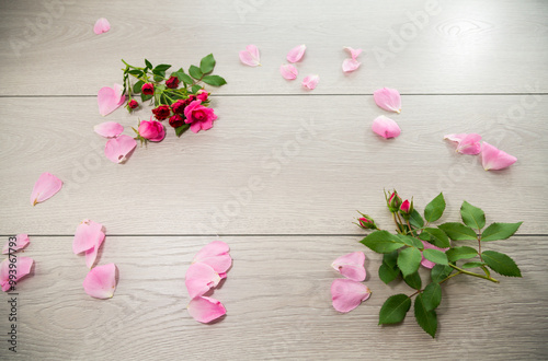 wooden light background with white and pink roses