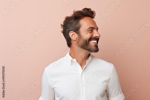 Portrait of a joyful man in his 30s wearing a classic white shirt in solid pastel color wall photo