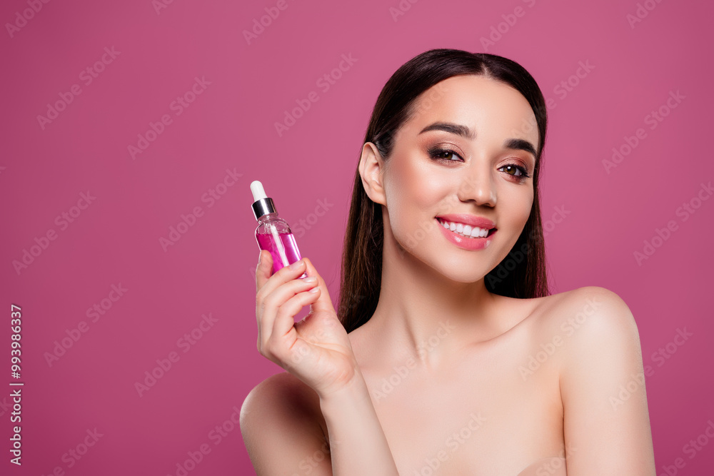 Photo of happy joyful girl hold serum bottle showing advertising on pink color background Photo of happy joyful girl hold serum bottle showing advertising on pink color background
