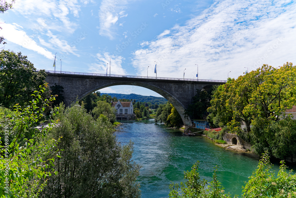 Scenic view of Limmat River and car bridge in the background with beautiful reflections on a sunny summer day at Swiss City of Baden. Photo taken August 19th, 2023, Baden, Canton Aargau, Switzerland. Scenic view of Limmat River and car bridge in the background with beautiful reflections on a sunny summer day at Swiss City of Baden. Photo taken August 19th, 2023, Baden, Canton Aargau, Switzerland.