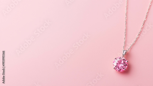 An elegant style of pink diamond necklace on a light pink background. 