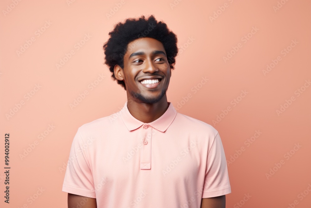 Portrait of a cheerful afro-american man in his 20s wearing a breathable golf polo isolated on solid pastel color wall Portrait of a cheerful afro-american man in his 20s wearing a breathable golf polo isolated on solid pastel color wall