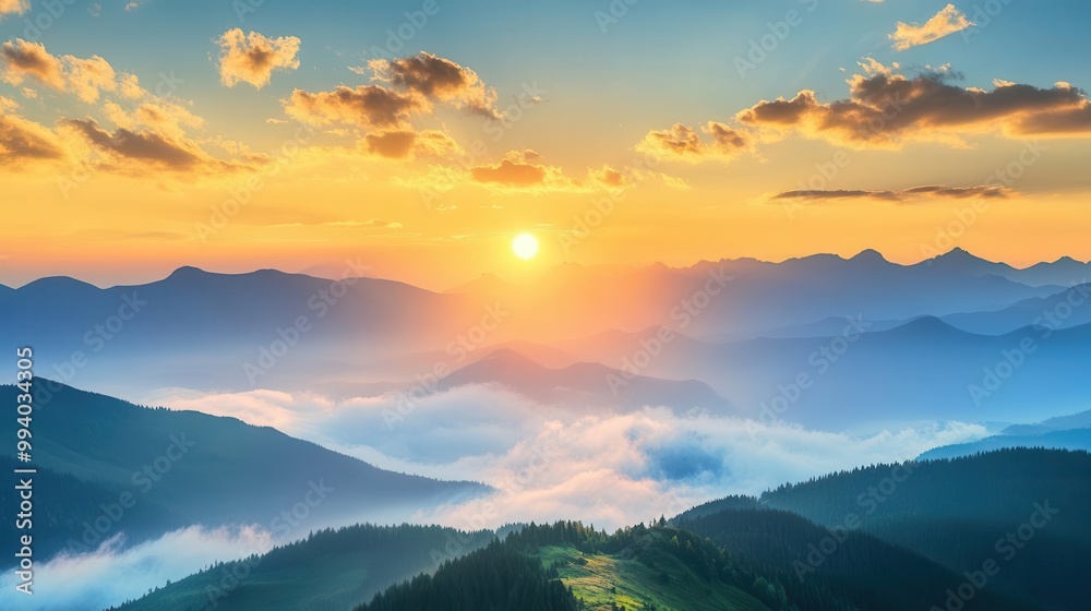 Fototapeta premium majestic sunrise over misty green mountains with golden light illuminating the peaks and fluffy clouds drifting across a brilliant blue sky