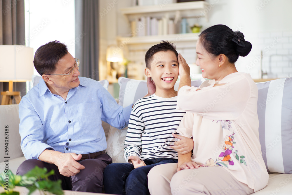 Asian family with father, mother, and son staying in living room together. Asian family with father, mother, and son staying in living room together.