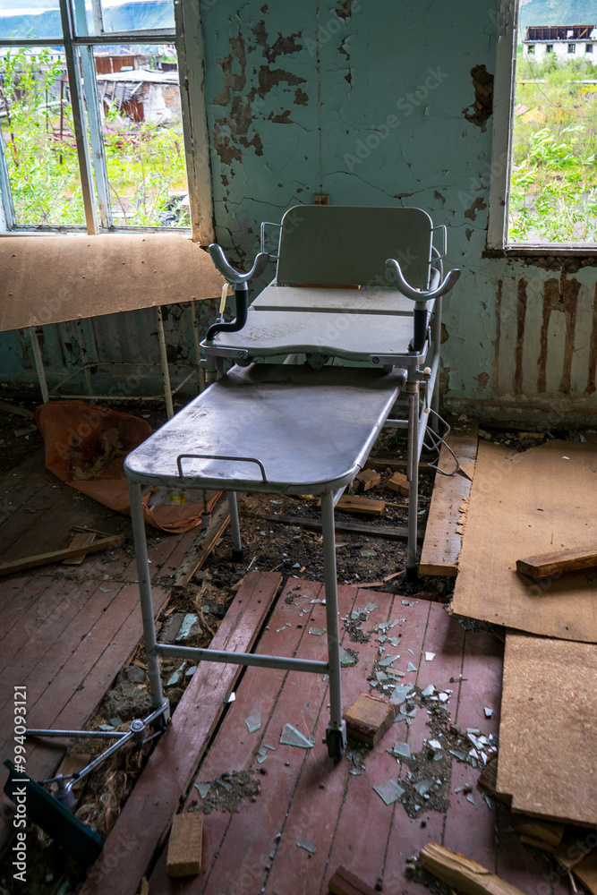 Gynecological examination table in an abandoned destroyed hospital.