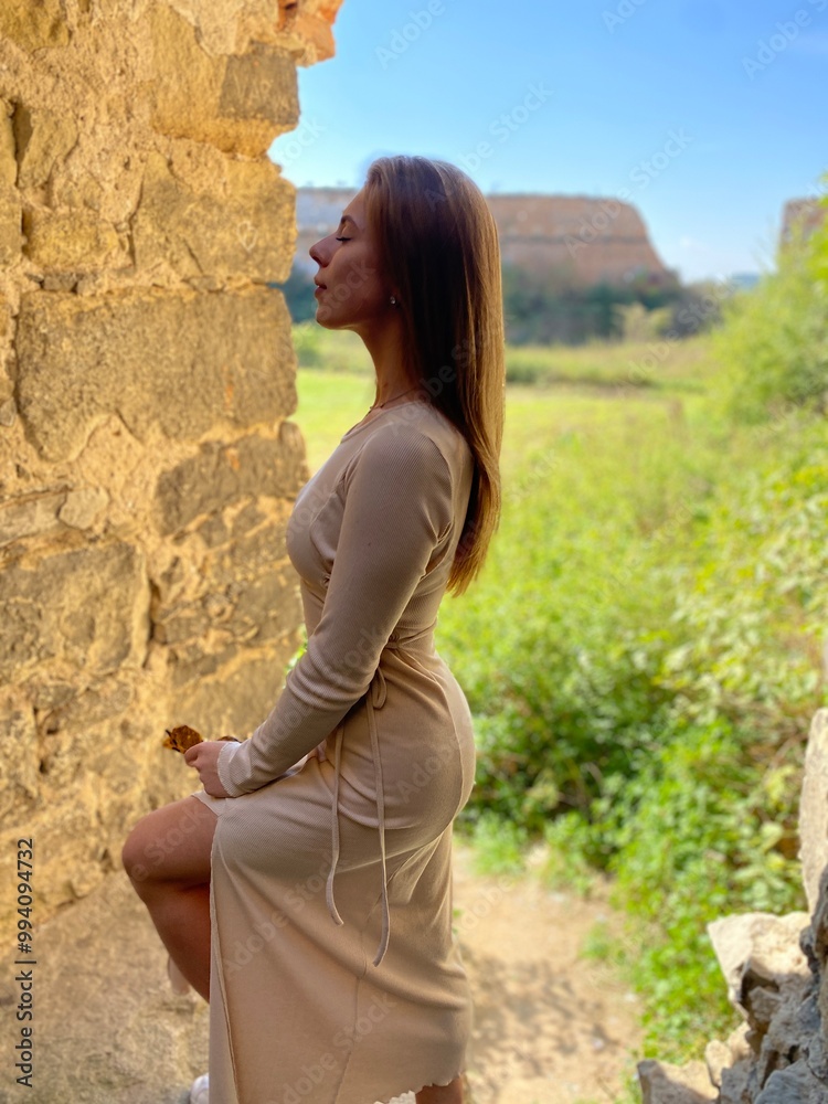 portrait of a woman standing near the ruins of an old castle portrait of a woman standing near the ruins of an old castle