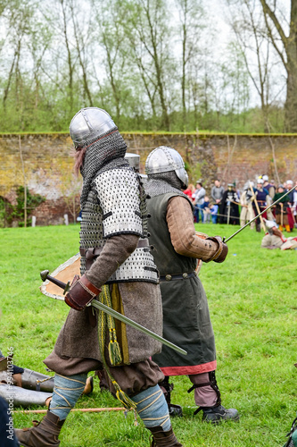 Knight fight, show fight of disguised knights and warriors, medieval soldiers with swords and shields at medieval market in Graefenthal Monastery, Goch, Kleve, North Rhine-Westphalia