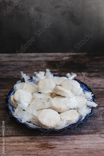 Traditional Christmas polvorones, nevaditos, mantecados or sweet cookies on plate fot holidays photo