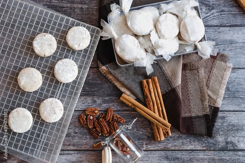 Baking polvorones traditional for Christmas season, or called nevaditos, mantecados or sweet cookies on plate for holidays. recipe and ingredients photo