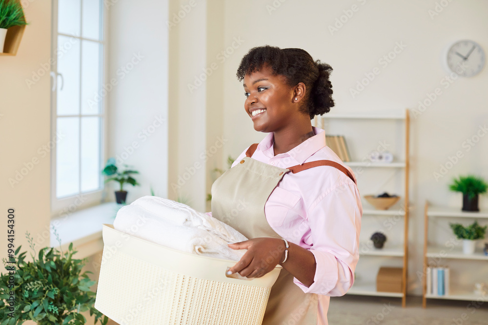 Happy middle aged african american woman with basket of textile, clothes, clean laundry pleasure, fresh smell, house after washing, professional cleaning worker, maid, janitor enjoying work, housewife Happy middle aged african american woman with basket of textile, clothes, clean laundry pleasure, fresh smell, house after washing, professional cleaning worker, maid, janitor enjoying work, housewife