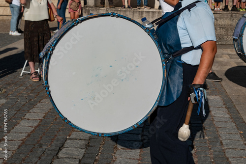 Musico e sua banda a acompanhar uma procissão com o seu ritmo numa festa tradicional photo