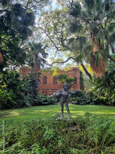 Bronze Statue of a Child with a Fish in the Lush Buenos Aires Botanical Garden