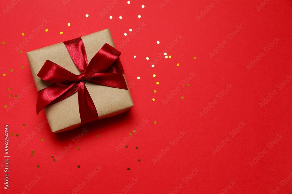 Beautiful gift box with confetti on a colored background Beautiful gift box with confetti on a colored background
