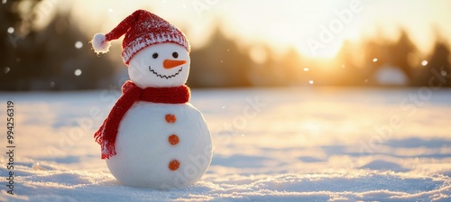 The winter holiday christmas background banner features a cute funny laughing snowman wearing a wool hat and scarf against a snowy snow landscape illuminated by bokeh lights (Stock).