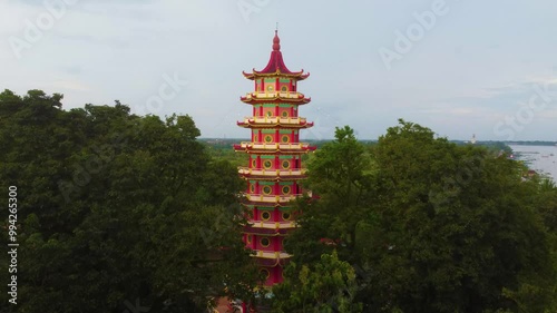 
Enchanting sunset at Pulau Kemaro, Palembang. The pagoda and klenteng by the riverside offer a picturesque view, perfect for serene visuals.
 photo