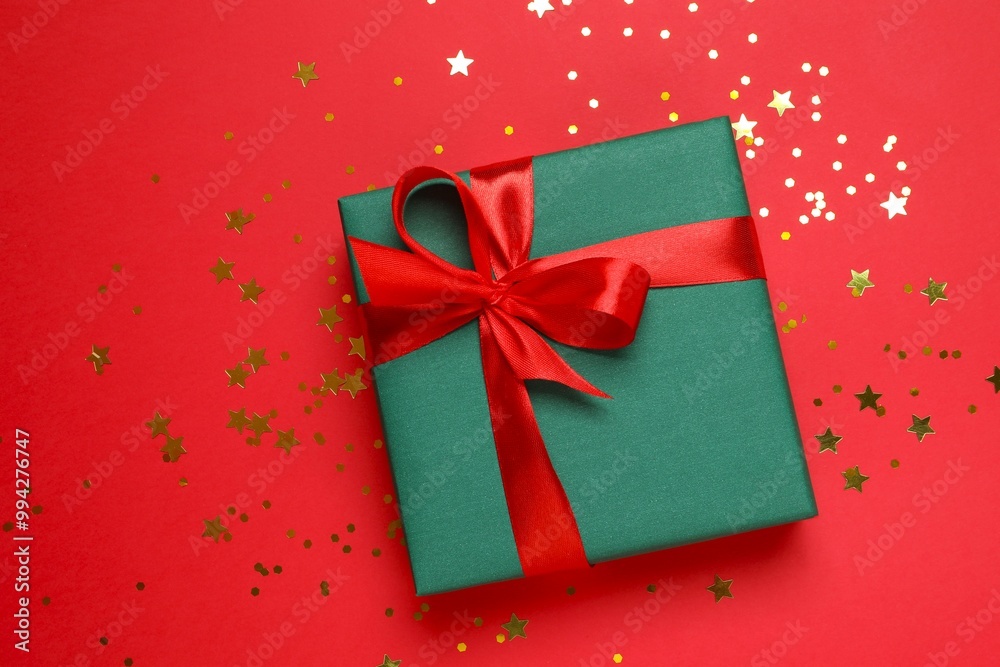 Beautiful gift box with confetti on a colored background Beautiful gift box with confetti on a colored background