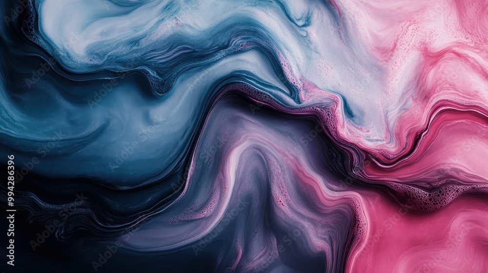 Fototapeta premium This image is an artistic display of swirling blue and pink paint patterns, creating an abstract, fluid representation that invokes a sense of movement and creativity.