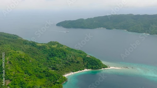 Tropical beach and boat running over the blue sea in Alad Island. Romblon, Philippines. photo