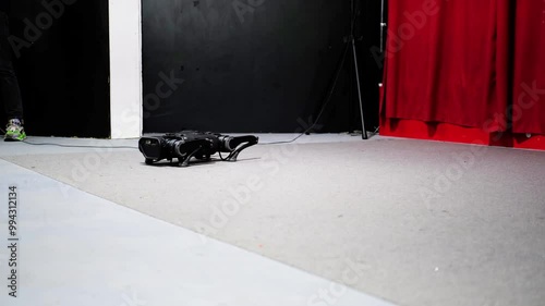 Quadruped robot dynamically rising after a fall, showcasing advanced motion capabilities and engineering design