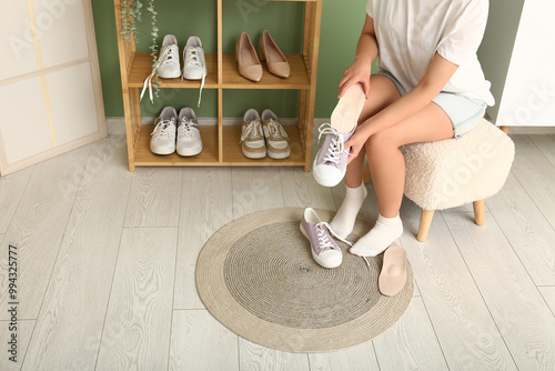 Young woman sitting on stoo...