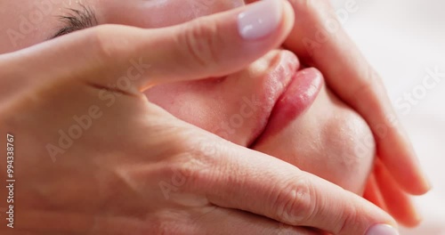 Wallpaper Mural Close up of masseur hands making facial relaxing massage to a young girl lying with closed eyes in beauty salon or cosmetology cabinet. Cosmetologist making massage for woman in spa. 4k video. Torontodigital.ca
