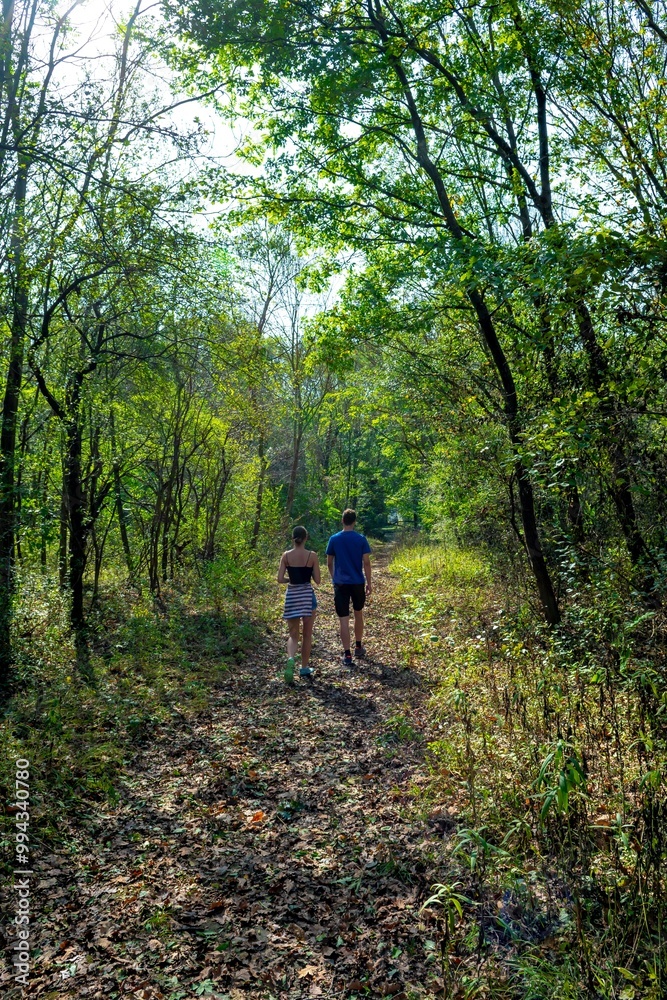 Young People On Hiking Trail Through Danube Wetlands National Park In Austria Young People On Hiking Trail Through Danube Wetlands National Park In Austria