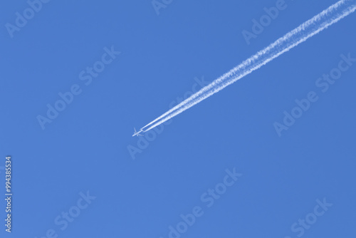 Telephoto close-up of jet plane aircraft with contrails cruising on the scottish sky